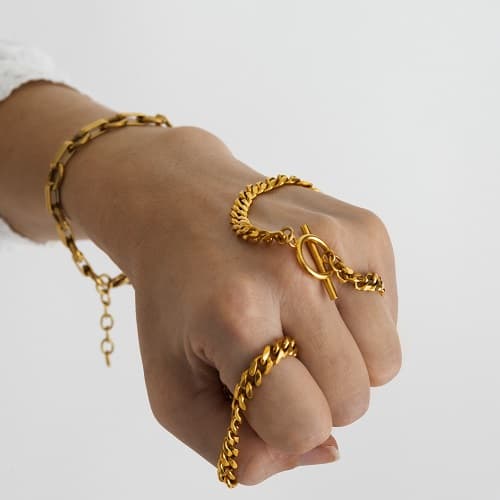 Hand wearing gold chains jewelry